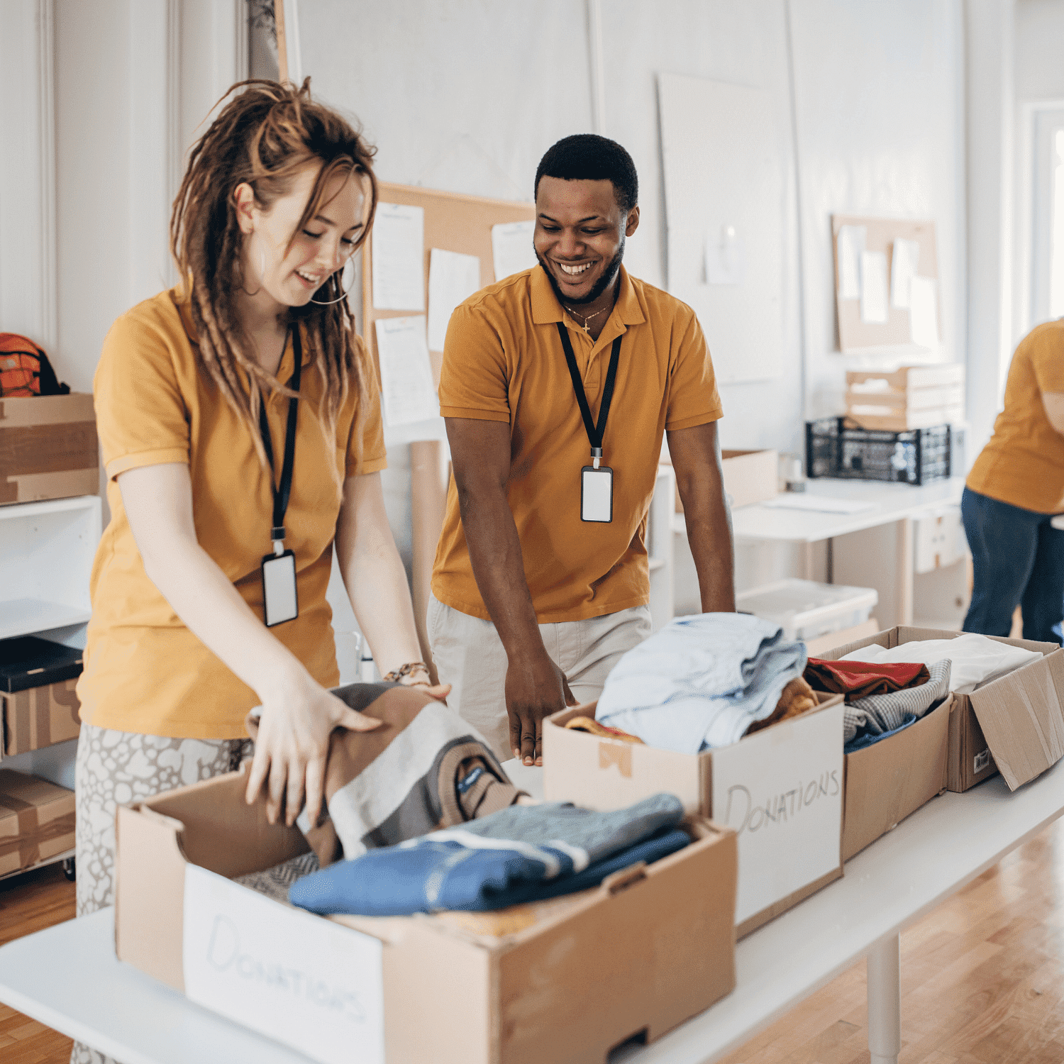 Volunteers sorting clothing donations in a community center.