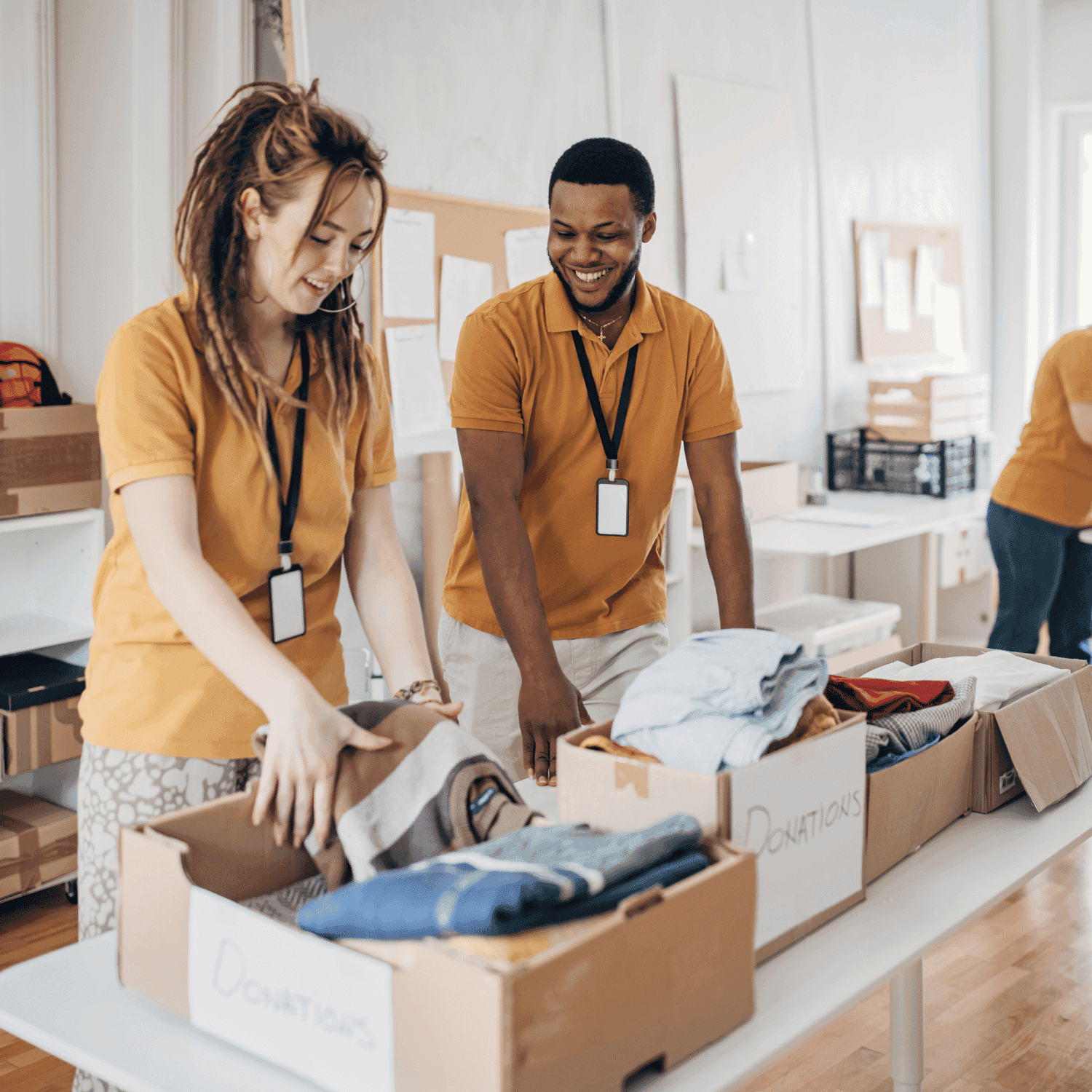 Volunteers sorting clothing donations in a community center.